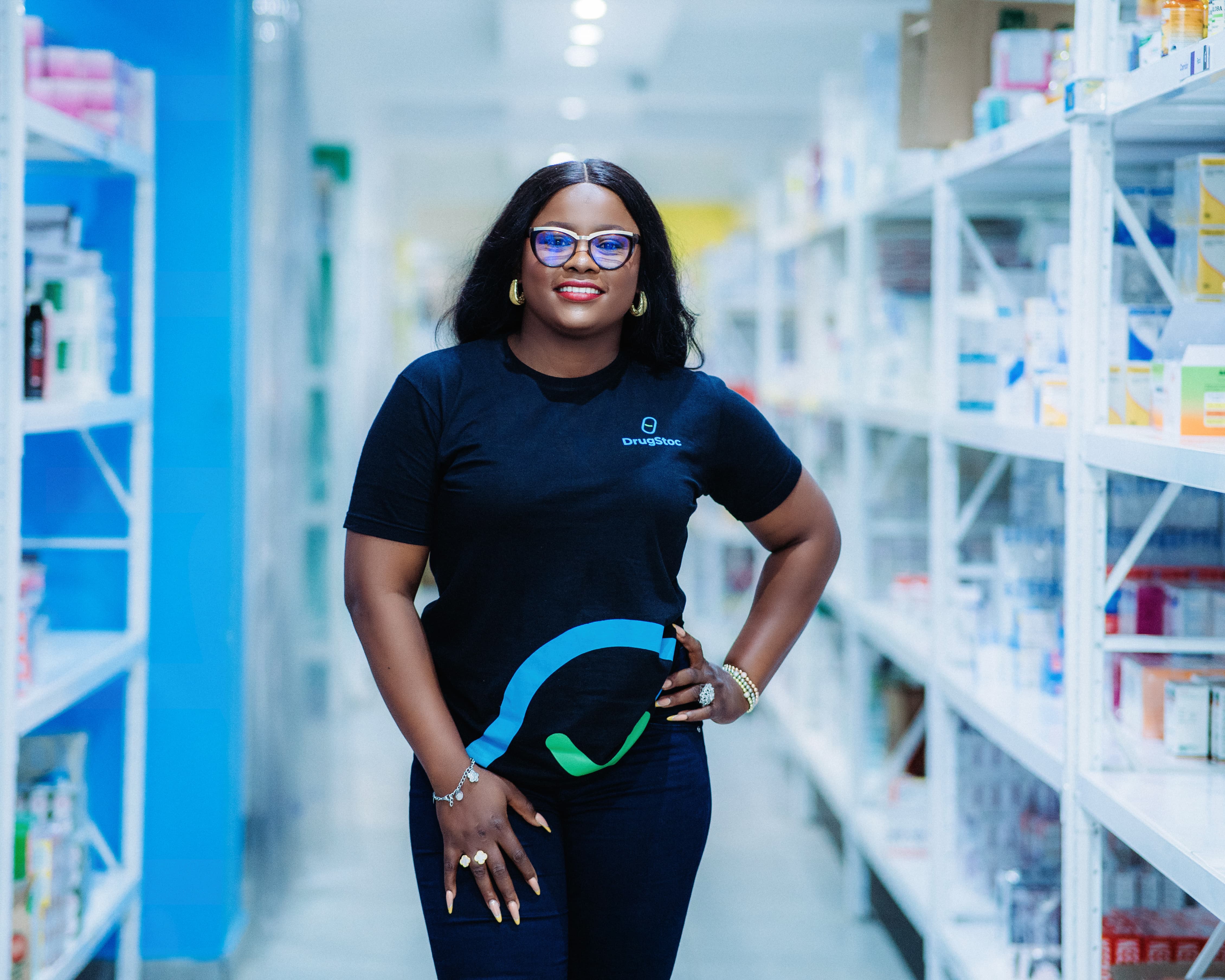 a contact support person at her office at DrugStoc wearing a black nose mask